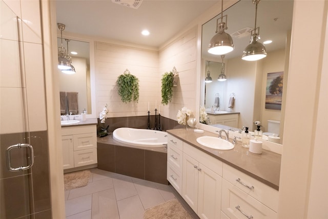 7175 US Highway 93 S, Lakeside, MT 59922 - bathroom featuring two vanities, tile patterned flooring, a garden tub, and a stall shower