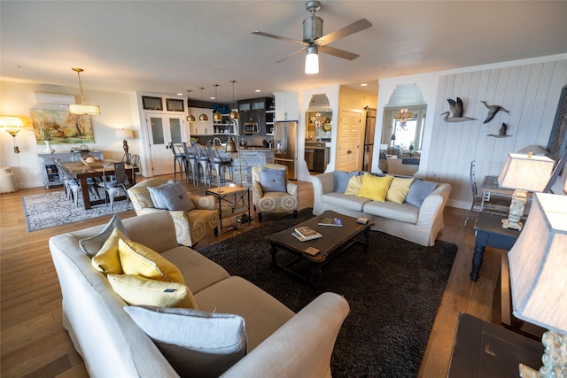 7175 US Highway 93 S, Lakeside, MT 59922 - living room with ceiling fan, light wood-style floors, and a wall unit AC