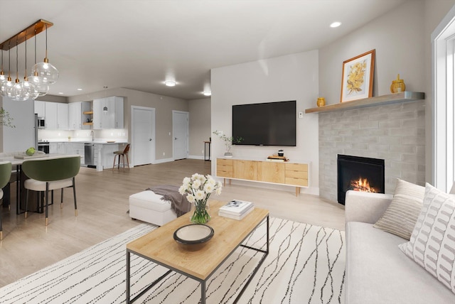 6201 Shiloh Ave Unit G, Whitefish, MT 59937 - living room with light wood-style floors, a fireplace, and recessed lighting