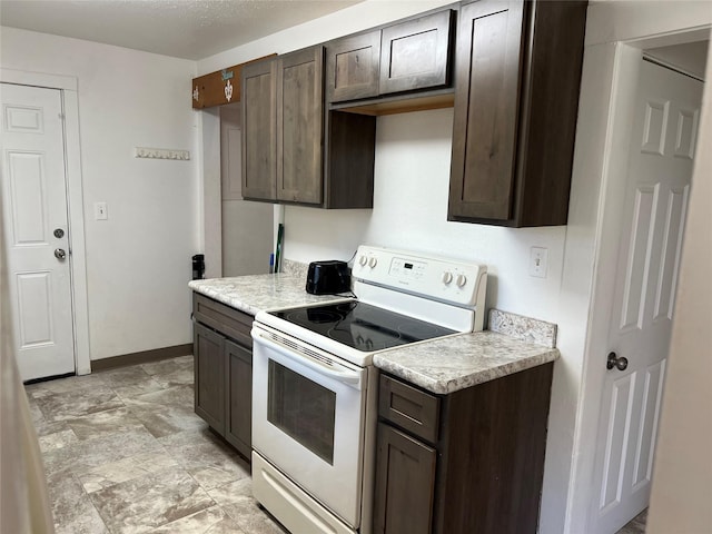 1717 2nd Ave N, Great Falls, MT 59401 - kitchen featuring white range with electric cooktop, dark brown cabinetry, and light countertops