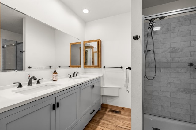 2206 US Highway 2 W, Kalispell, MT 59901 - full bathroom featuring double vanity, wood finished floors, a tile shower, and recessed lighting