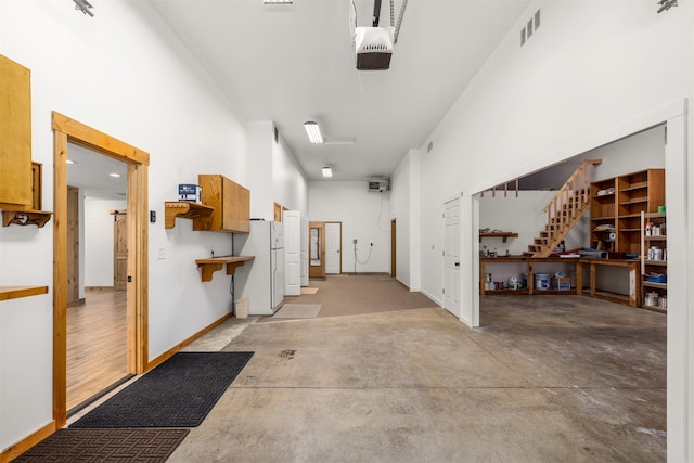 2206 US Highway 2 W, Kalispell, MT 59901 - garage featuring freestanding refrigerator and a garage door opener
