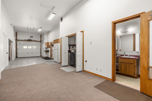 2206 US Highway 2 W, Kalispell, MT 59901 - garage featuring washer / clothes dryer and freestanding refrigerator
