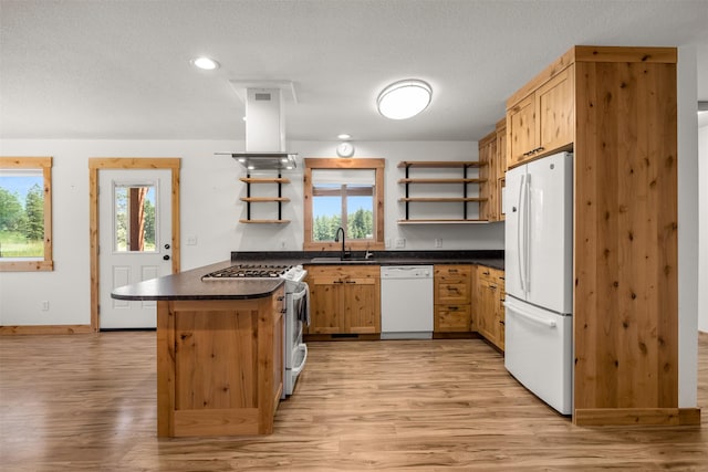 2206 US Highway 2 W, Kalispell, MT 59901 - kitchen with open shelves, white appliances, dark countertops, light wood-type flooring, and a textured ceiling