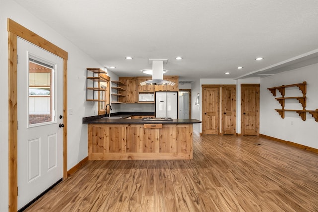 2206 US Highway 2 W, Kalispell, MT 59901 - kitchen featuring open shelves, white appliances, a peninsula, recessed lighting, and light wood-style floors