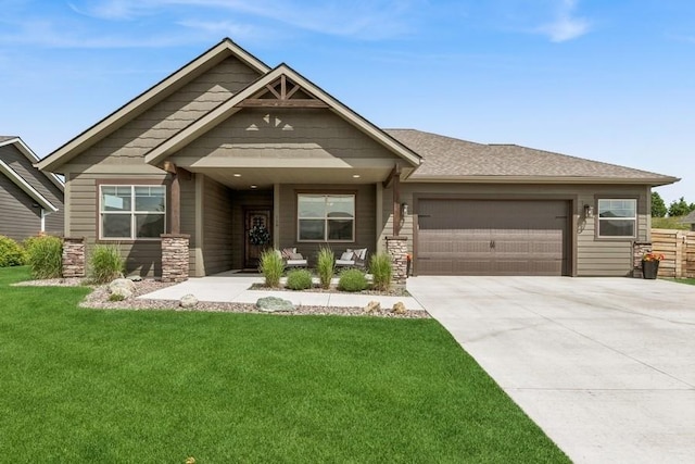 158 Swede Trl, Kalispell, MT 59901 - view of front of property with stone siding, a garage, a front yard, and driveway