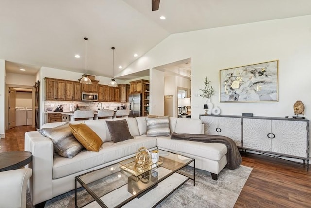 158 Swede Trl, Kalispell, MT 59901 - living area with vaulted ceiling, separate washer and dryer, dark wood-style flooring, recessed lighting, and a ceiling fan