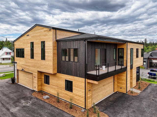 134 2nd St W Unit B, Whitefish, MT 59937 - view of home's exterior featuring an attached garage, driveway, and a balcony