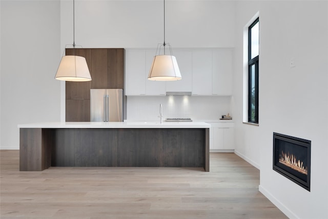 134 2nd St W Unit B, Whitefish, MT 59937 - kitchen with stainless steel appliances, modern cabinets, white cabinets, light countertops, and decorative backsplash