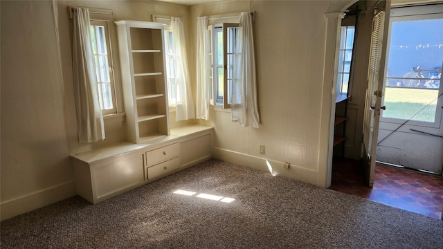 839 Evans Ave, Missoula, MT 59801 - unfurnished dining area with dark carpet and baseboards