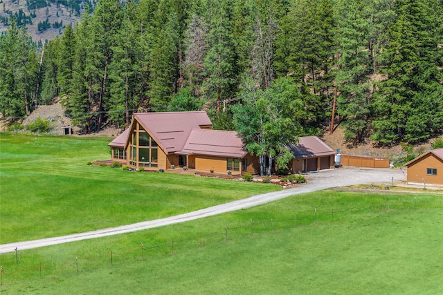 48 Rock Creek Rd, Clinton, MT 59825 - view of front facade featuring driveway, a forest view, and a garage