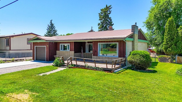 1108 5th St E, Polson, MT 59860 - view of front of property featuring a chimney, an attached garage, concrete driveway, a metal roof, and board and batten siding