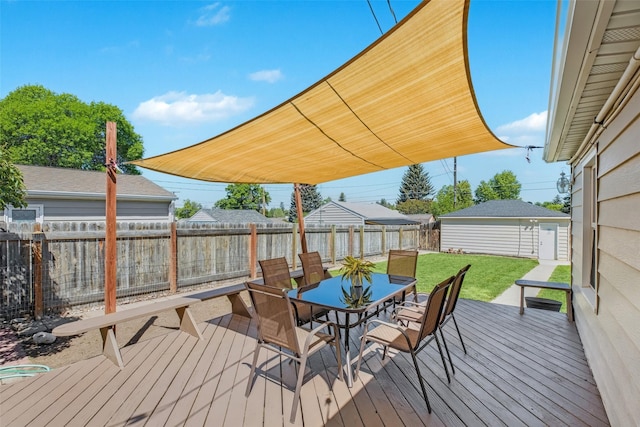 2321 8th Ave S, Great Falls, MT 59405 - deck with outdoor dining area, a fenced backyard, and an outbuilding