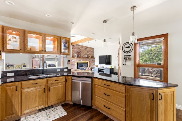 2604 5th Ave S, Great Falls, MT 59405 - kitchen with stainless steel dishwasher, dark wood finished floors, a peninsula, lofted ceiling, and glass insert cabinets