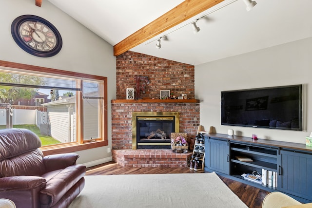 2604 5th Ave S, Great Falls, MT 59405 - living room with track lighting, a brick fireplace, and dark wood-style floors