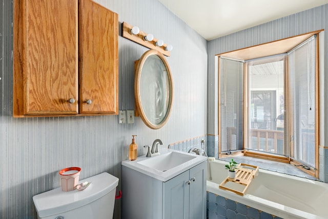 2604 5th Ave S, Great Falls, MT 59405 - bathroom featuring wallpapered walls, vanity, and tiled tub
