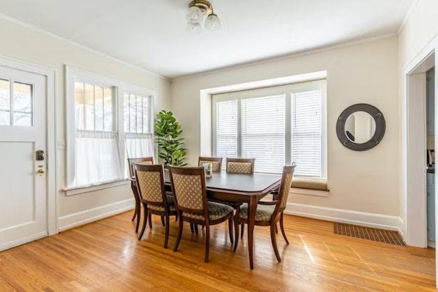 1046 3rd Ave E, Kalispell, MT 59901 - dining area with ornamental molding and light wood-style floors