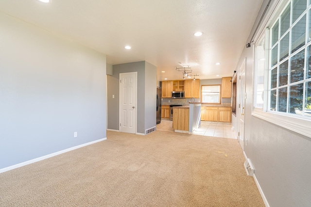 408 23rd Ave NE, Great Falls, MT 59404 - kitchen with stainless steel appliances, a kitchen island, light carpet, recessed lighting, and open floor plan