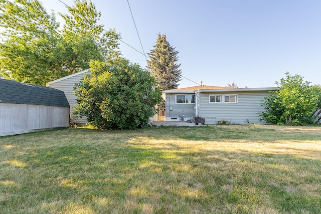 408 23rd Ave NE, Great Falls, MT 59404 - view of grassy yard featuring a storage unit and a patio
