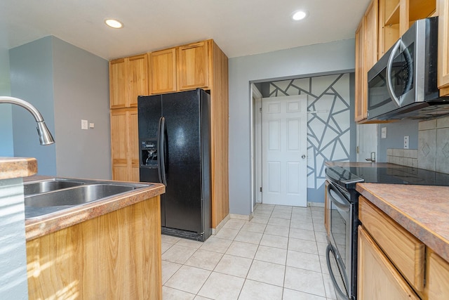 408 23rd Ave NE, Great Falls, MT 59404 - kitchen with black appliances, light tile patterned floors, recessed lighting, and light brown cabinets