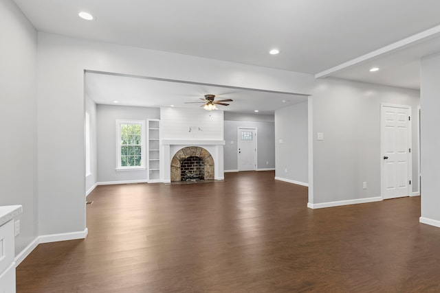 unfurnished living room with ceiling fan and dark wood-type flooring