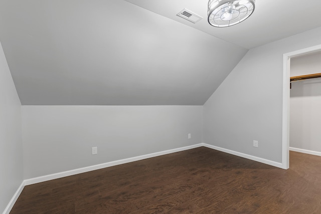 bonus room featuring dark hardwood / wood-style flooring and lofted ceiling