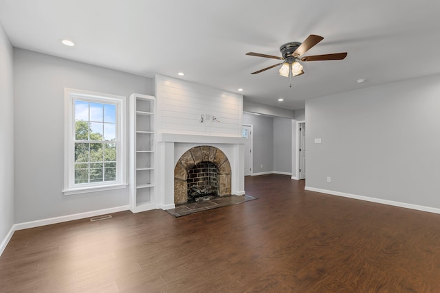 unfurnished living room with ceiling fan and dark wood-type flooring