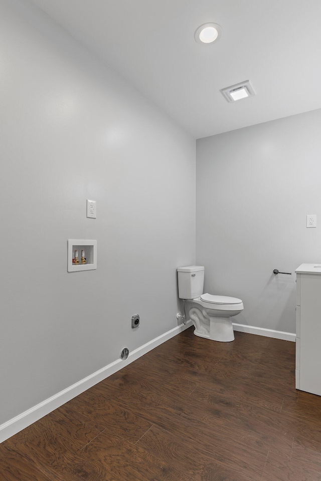 bathroom with hardwood / wood-style floors, vanity, and toilet