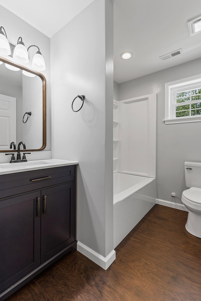 bathroom featuring toilet, vanity, and hardwood / wood-style flooring