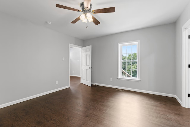 unfurnished bedroom with ceiling fan and dark wood-type flooring