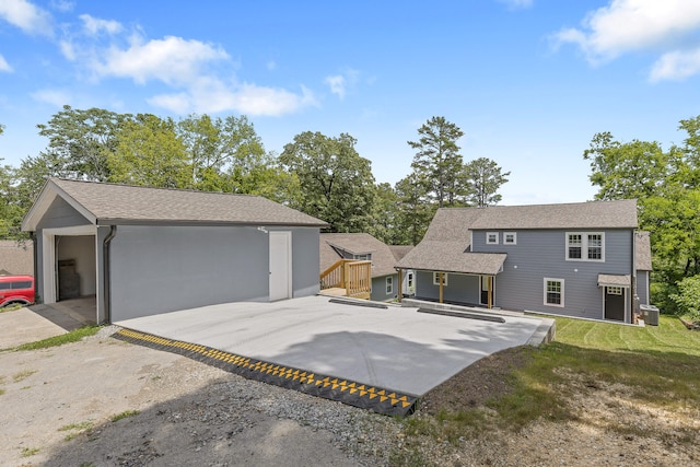 view of front of house with central AC and a front lawn