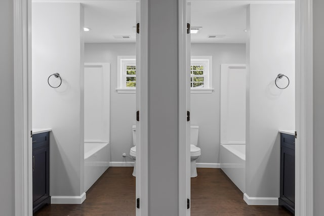 full bathroom with hardwood / wood-style flooring, vanity, and toilet