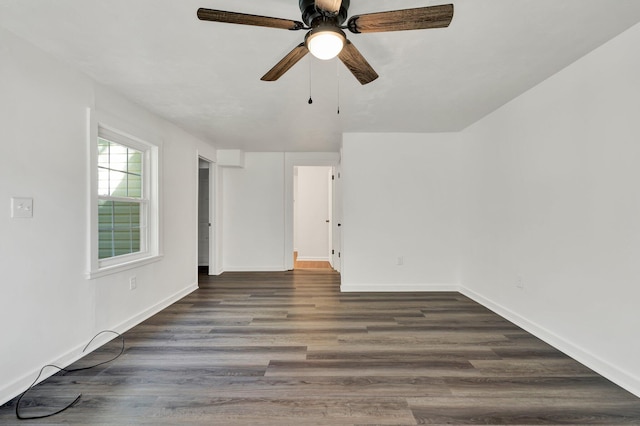 empty room featuring ceiling fan and dark hardwood / wood-style flooring