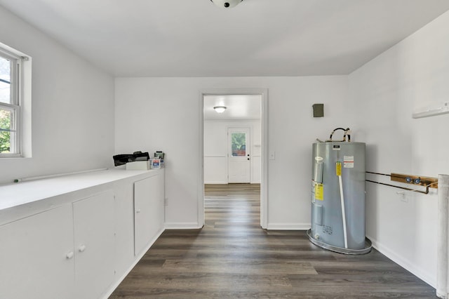 interior space featuring dark hardwood / wood-style floors and electric water heater