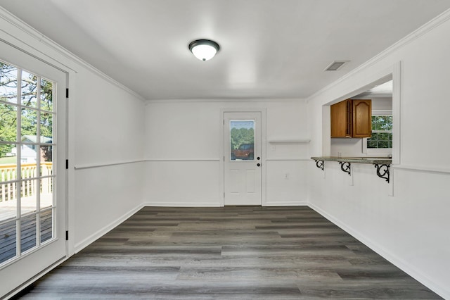 interior space featuring crown molding and dark hardwood / wood-style floors