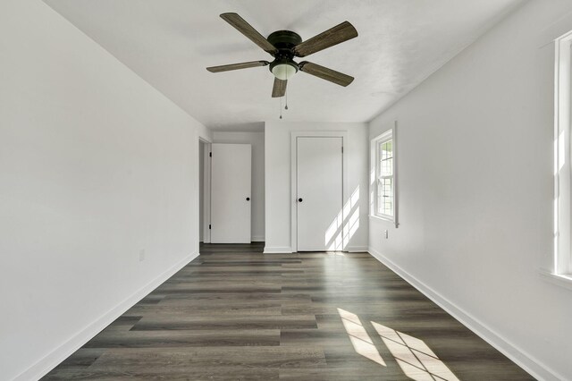 unfurnished room with dark hardwood / wood-style floors and ceiling fan