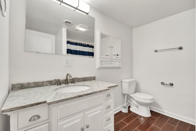 bathroom featuring hardwood / wood-style floors, vanity, toilet, and a shower with shower curtain