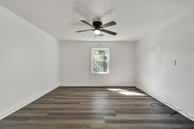 spare room with ceiling fan and dark wood-type flooring