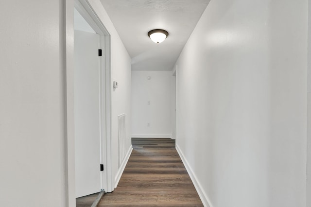 hallway featuring dark wood-type flooring