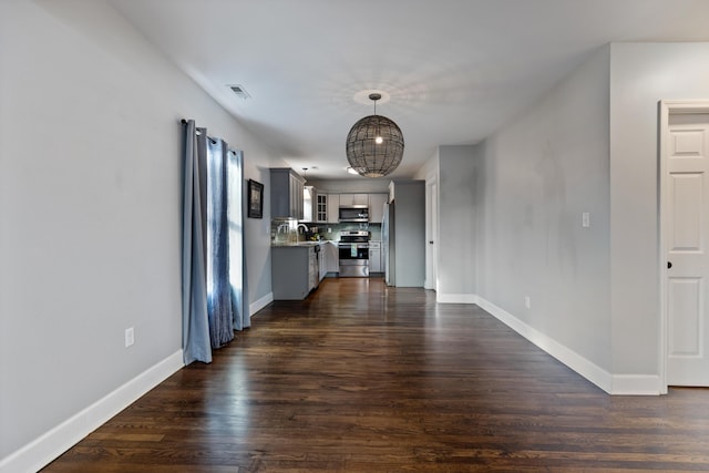 unfurnished living room with sink and dark hardwood / wood-style flooring