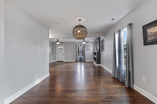 interior space with ceiling fan and dark hardwood / wood-style flooring