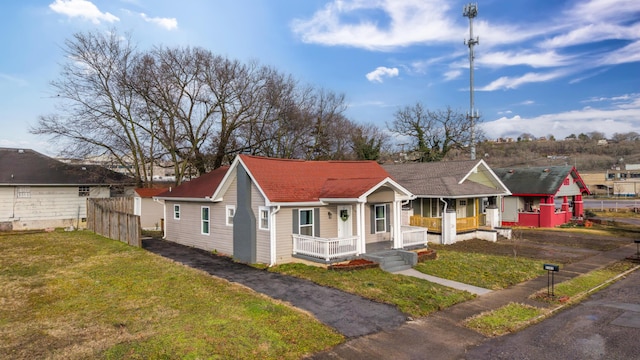 bungalow-style home featuring a front lawn and covered porch