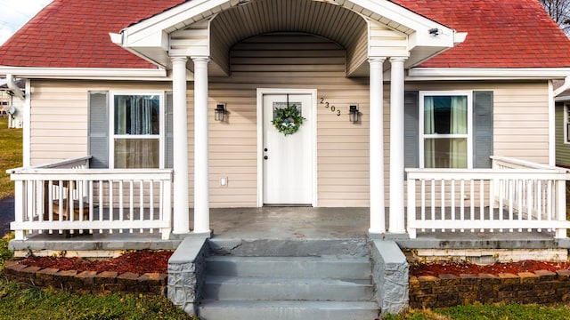 view of exterior entry with covered porch