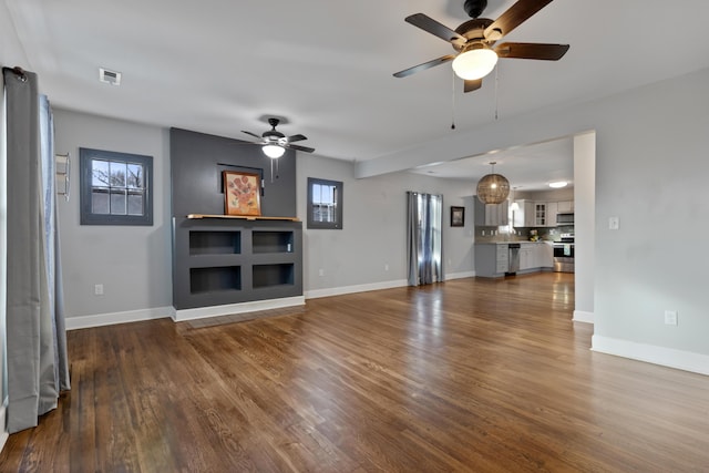 unfurnished living room with plenty of natural light, hardwood / wood-style floors, and ceiling fan