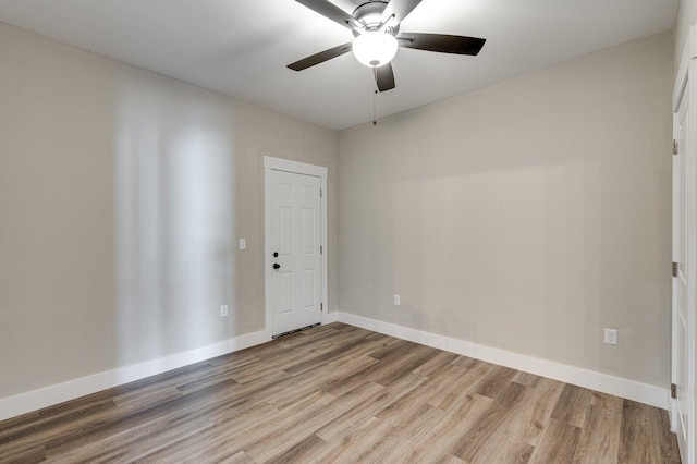 spare room featuring wood-type flooring and ceiling fan