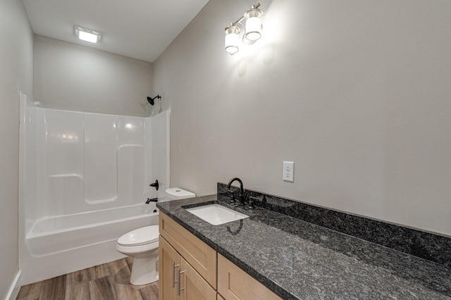 full bathroom with hardwood / wood-style flooring, shower / bathtub combination, vanity, and toilet