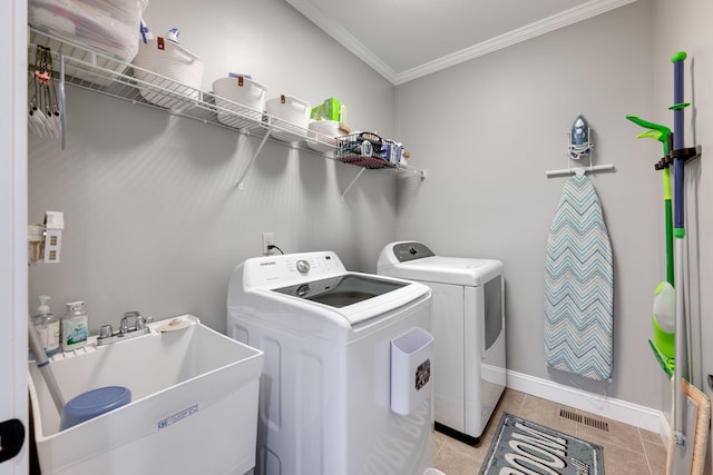 clothes washing area with a sink, independent washer and dryer, laundry area, crown molding, and visible vents