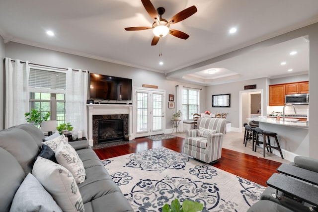 living room featuring ornamental molding, recessed lighting, a ceiling fan, and dark wood-style flooring