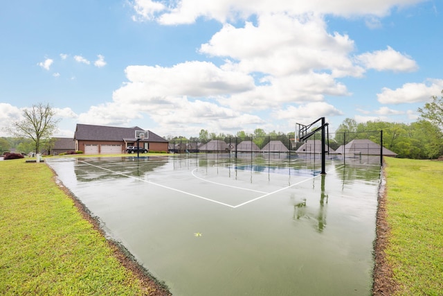 view of sport court featuring a tennis court, a yard, community basketball court, and fence