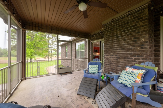 sunroom / solarium featuring ceiling fan and plenty of natural light
